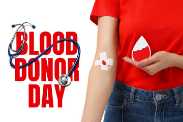 Person in red holds a blood droplet and shows a bandage