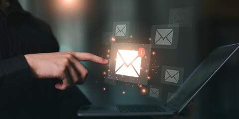 A person using a laptop with a glowing new email notification icon, representing email marketing,...