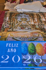 A 2026 calendar featuring the Virgen de las Angustias of Granada, adorned with gold and flowers inside a richly decorated church. devotion tradition