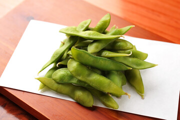 Fresh Boiled Edamame Soybeans on Wooden Table
