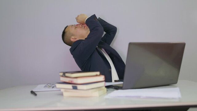 Office man putting eye drops in his eyes in front of computer. Mature man applies eye drops to relieve eye fatigue.