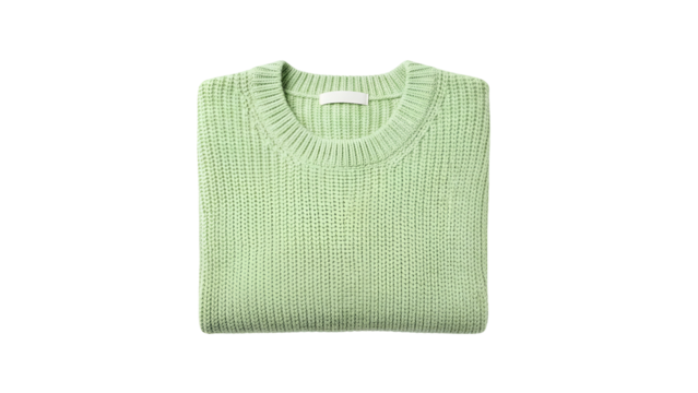 Folded pale green knit pullover garment rests isolated against a solid dark background