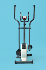 Modern exercising bike on blue background