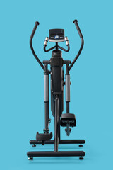 Modern elliptical machine on blue background