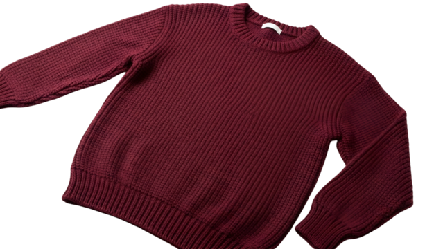 Warm, ribbed knit garment in a deep maroon color shown against a dark background