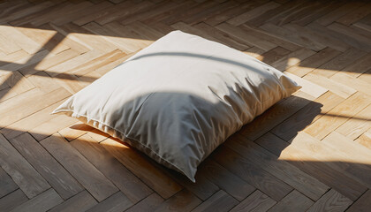 Soft white pillow on wooden floor illuminated by morning sunlight and natural shadows, minimalist home interior concept for relaxation, comfort, and bedroom design mockup.