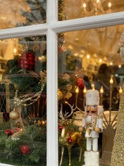 Nutcracker in Window with Christmas Decorations