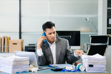Professional office worker managing phone call and report review simultaneously, showing multitasking and corporate efficiency.