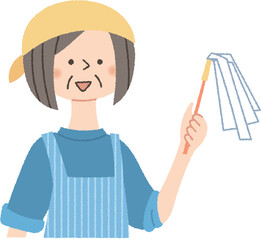はたきを持っているシニア女性
