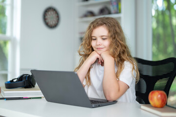 E-learning. Home learn for child. Kid learning on laptop e-learning. Teen student learn lesson on laptop. Child study schoolwork in home classroom interior. Online learn. Education and learning online