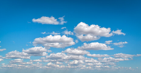 Calm sky and open atmosphere. Space for text layer background design. Panorama of sky with clouds on a sunny day.