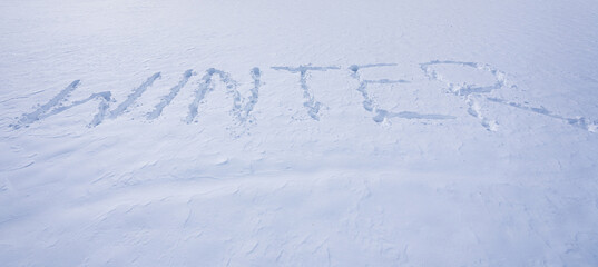 Winter text on snowy background. Snowy banner design in cold weather. Winter text with snowflakes. Snow background with winter text.