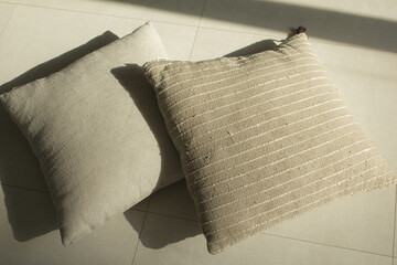 beige cushions lying on the floor