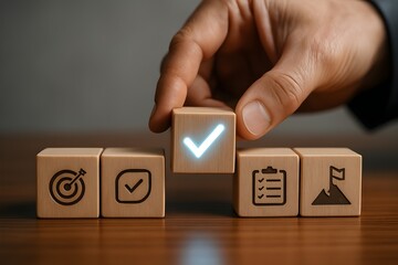 Hand completing a project workflow with wooden blocks, symbolizing goal achievement and task completion