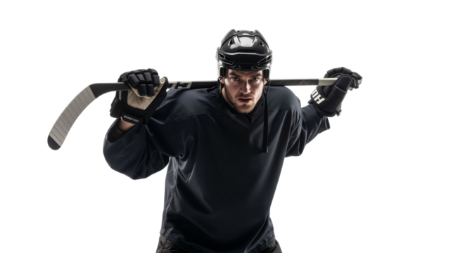 Determined hockey player poses with equipment against bright background