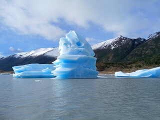 Stunning iceberg floating in the cold waters of Patagonia, Argentina, showcasing brilliant shades of blue and white in a pristine natural landscape