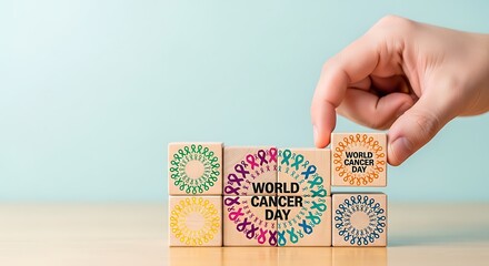 World Cancer Day campaign message constructed with wooden blocks and awareness ribbons