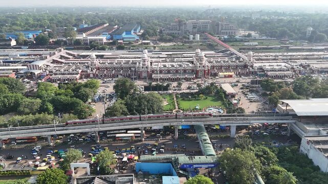 Aerial shot of Running Metro Train in front of Charbagh Railway  station in Lucknow, Uttar Pradesh, India