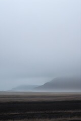 Misty Icelandic Landscape Dark Mountains Pale Sky image