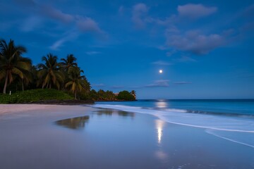 Tropical beach at twilight with full moon reflecting on wet sand and calm ocean waves water