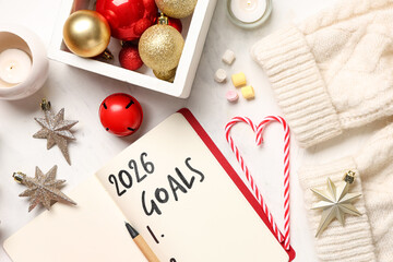 Notebook with 2026 goals and Christmas decor on white background