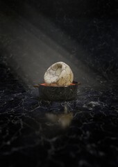 3d rendered deflated soccer ball in a marble bowl under dramatic lighting illuminated on a dark marble surface