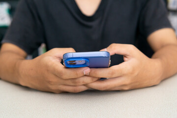 Close up view of a young man using a smartphone