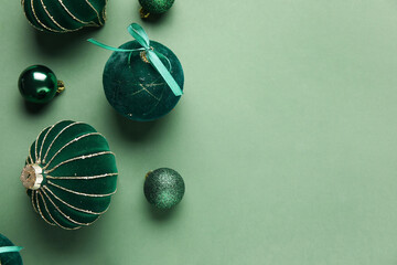 Different Christmas balls on green background