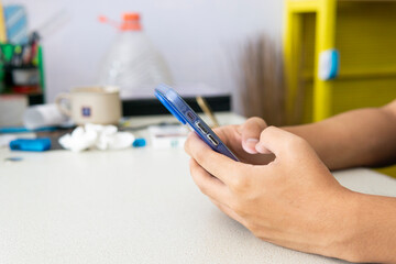 Close up view of a young man using a smartphone
