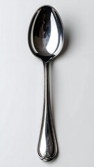 Overhead shot of a shiny, silver utensil with a deep bowl, on white