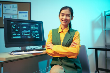 An Asian businesswoman analyzes digital charts on a computer screen, reviewing performance reports and financial data to develop strategic business insights and support decision-making in a modern
