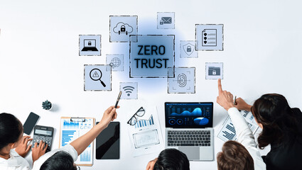 A diverse group of business professionals engages in a strategic discussion on digital security, highlighting the importance of the Zero Trust model and modern solutions. Trope