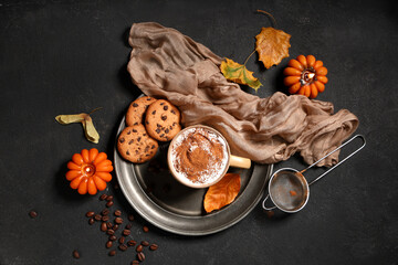 Composition with mug of tasty coffee, cookies and burning candles on black grunge background