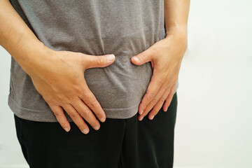 Hernia, Asian man stomach ache, abdominal pain and urology problem health.