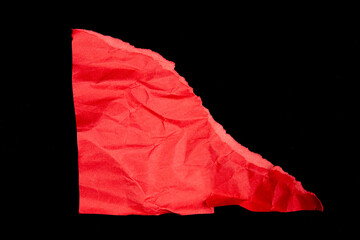 Crumpled red paper pieces isolated on black background