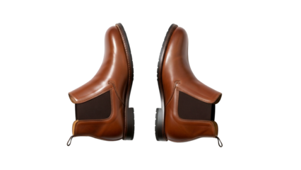 Pair of classic leather ankle boots displayed facing each other against a dark background
