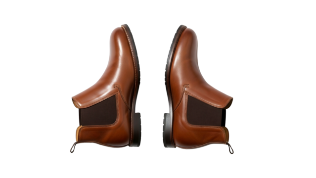 Pair of classic leather ankle boots displayed facing each other against a dark background