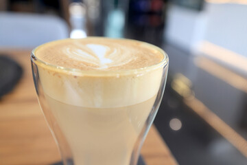 cappuccino, coffee in a clear glass cup in a cafe, soft color background food and drink, hot drink
