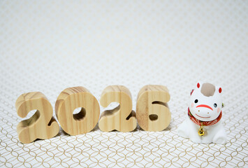 可愛い馬の置物と七宝柄の背景の年賀状素材