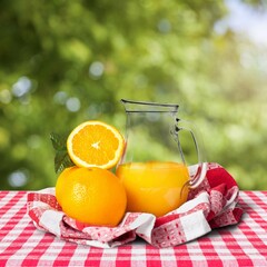 Orange juice with fresh fruits in farming background.