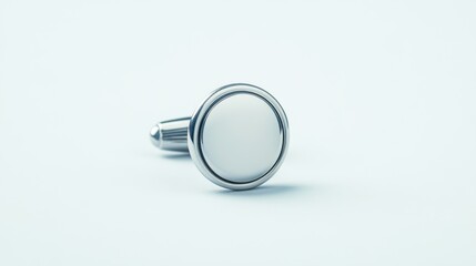 Elegant silver cufflink with a polished surface on a light background showcasing classic fashion accessories for men