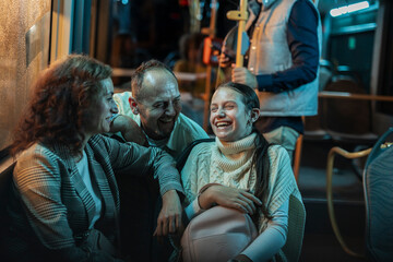 Family laughing on night bus feeling joy