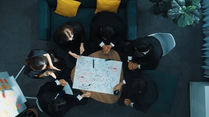 Top down aerial view of group of business people brainstorm marketing idea while writing mind map. Time lapse of creative team working together to share strategy while using mind mapping. Directorate.