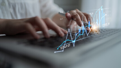 A business person types on a laptop keyboard while financial graphs and data overlays illustrate market trends and analysis in a modern workspace. Scalp