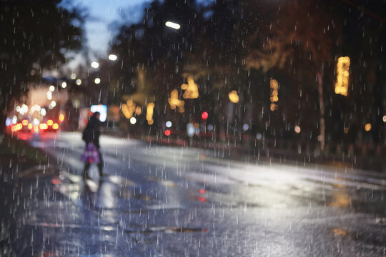 Fototapeta Rainy weather background on a city street, road with cars and drops of autumn rain in blur