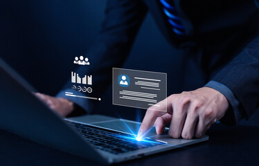 Businessman using laptop with virtual interface showing data analytics, HR management, and digital technology concept. Modern business strategy, innovation, and corporate performance analysis.