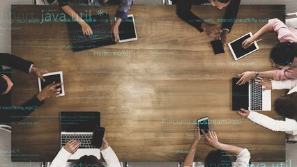 A modern office setting featuring a diverse team engaged in collaborative discussions, utilizing laptops and tablets for coding and innovative ideas. Xenic