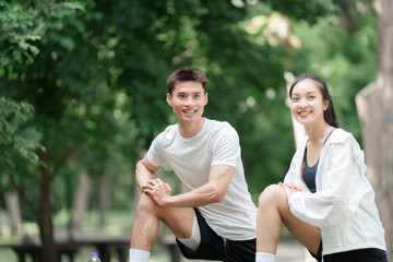 Healthy young couple stretching, preparing for outdoor workout
