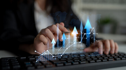 A businesswoman analyzing digital financial trends over a keyboard. The image captures the essence...