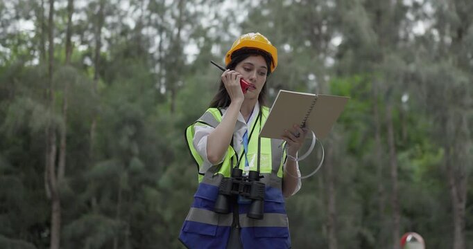 Female environmental engineer conducts field survey in pine forest, measuring, documenting tree diameter for carbon credit verification. Climate action, green forestry, ecological conservation efforts
